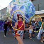 Maureen Monroe, representing the New Old Time Chautauqua stage show, spins hoops as part of their Independence Parade entry. (Keith Thorpe/Peninsula Daily News)