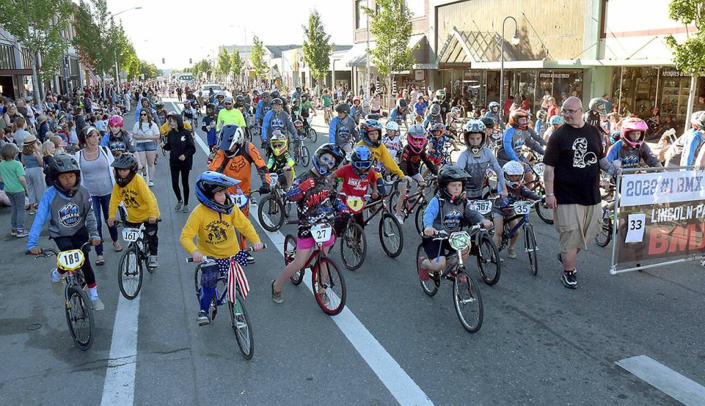 BMX racers cruise First Street with the Lincoln Park BMX Track parade entry. (Keith Thorpe/Peninsula Daily News)