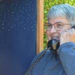 Diane Fatzinger uses the wind phone in Sequim, located just north of the Olympic Discovery Trail on West Hendrickson Road. (Elijah Sussman/Olympic Peninsula News Group)