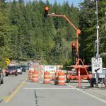 One-way alternating traffic makes its way across the U.S. Highway 101 bridge over the Elwha River southwest of Port Angeles. The bridge is scheduled for a nine-day closure beginning at 6 p.m. Friday through 5 a.m. July 22 as crews connect the new bridge with the old roadway. During the closure, travelers will detour onto state Highways 112 and 113. (Keith Thorpe/Peninsula Daily News)