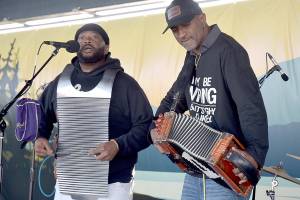 Curley Taylor, frontman for Louisiana-based Curley Taylor and Zydeco Trouble, right, performs with bandmate Matthey Roberts on rubboard during Wednesday nights Concert on the Pier at Port Angeles City Pier. The free weekly music series, hosted by the Juan de Fuca Foundation and sponsored by Strait View Credit Union, D.A. Davidson & Co., 102.1 FM The Strait and the Peninsula Daily News, continues at 6 p.m. Wednesday with rock and dance band The Nasty Habits. (Keith Thorpe/Peninsula Daily News)