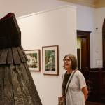 Terri Mack takes in Jeanne K Simmons burnt cedar sculpture, Grief Monument for Corbin on July 11. (Elijah Sussman/Peninsula Daily News)