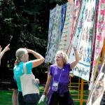 Bernadette Shein helps answer quilt questions for visitors of the Sunbonnet Sue Quilt Clubs annual quilt show in 2023. This year, the event will move to Trinity United Methodist Church and expand to two days, Friday and Saturday. (Matthew Nash/Olympic Peninsula News Group)