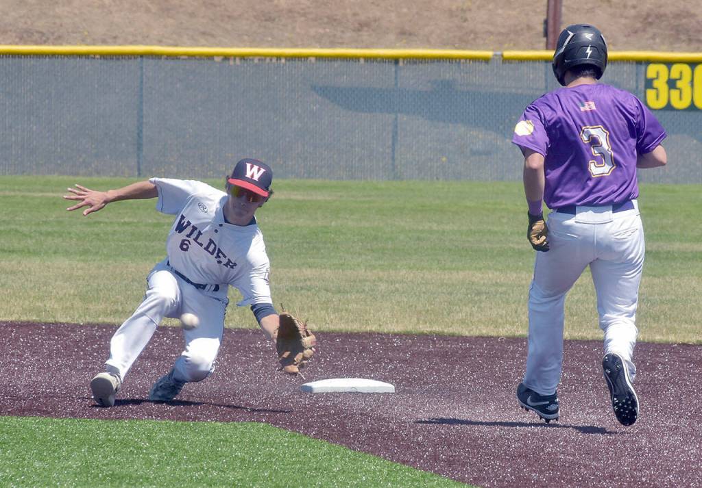 KEITH THORPE/PENINSULA DAILY NEWS Wilder Junior shortstop Bryce DeLeon takes the throw from home to cut off a steal attempt by Pipeline Pirate AAA baserunner Matt Noa on Saturday at Volunteer Field in Port Angeles.