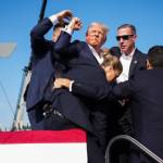 Former President Donald J. Trump is rushed from the stage at a rally in Butler, Pa., on Saturday. (Doug Mills/The New York Times)
