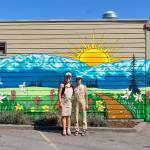Emily Little, left, owner of Buena Luz Bakery, and artist Gianna Andrews stand in front of the mural.