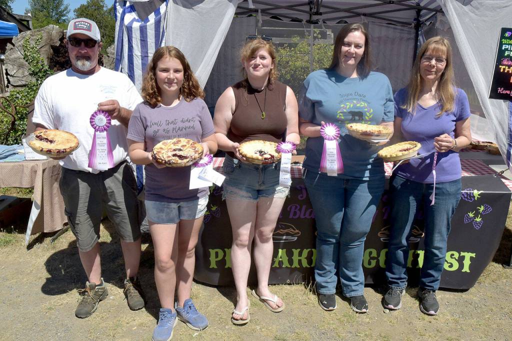 Joyce Daze Wild Blackberry Festival pie contest winners gather after receiving their ribbons and prizes. Winners were, from left, Jim Hill of Port Angeles, third-place adult; Audrey Price, 12, of Joyce, second-place youth; Ariana Varholl of Sequim, first-place youth; Tamara Stephens of Clackamas, Ore., second-place adult; and Janice Harsh of Joyce, first-place adult. (Keith Thorpe/Peninsula Daily News)