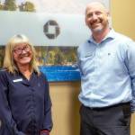 Elva Hulett, left, and James Hoch, Port Angeles' Chase Bank branch manager, right, smiling together, reminiscing Elva's milestone achievement at Chase Bank on August 8, 2024. (Christopher Urquia/Peninsula Daily News)