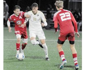 KEITH THORPE/PENINSULA DAILY NEWS
Peninsula's Nil Grau, center, fights off Skagit Valley's Fernando Velazquez at Peninsula College's Wally Sigmar Field last season. Grau, who scored eight goals last year for the Pirates, returns for his sophomore season this year.