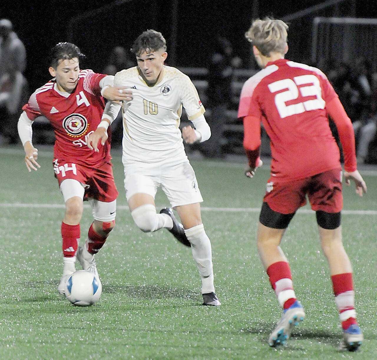 KEITH THORPE/PENINSULA DAILY NEWS Peninsulas Nil Grau, center, fights off Skagit Valleys Fernando Velazquez at Peninsula Colleges Wally Sigmar Field last season. Grau, who scored eight goals last year for the Pirates, returns for his sophomore season this year.