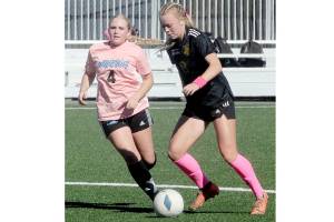 Peninsulas Anna Petty, right, advances the ball past Whatcoms Tori Oord during a match last year at Wally Sigmar Field in Port Angeles. Petty, who scored 12 goals last year, is back for the Pirates this season. (Keith Thorpe/Peninsula Daily News)