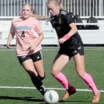 Peninsulas Anna Petty, right, advances the ball past Whatcoms Tori Oord during a match last year at Wally Sigmar Field in Port Angeles. Petty, who scored 12 goals last year, is back for the Pirates this season. (Keith Thorpe/Peninsula Daily News)