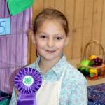 Anna-Marie Tax poses with the champion ribbon she won for decorating her cat Priscillas cage. (Dave Logan/For Peninsula Daily News)