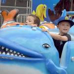 Cevoun Anders, 5, of Port Angeles, left, and Brixton Dennis, 3, of Sequim take a ride on the Flying Fish amusement ride at the Clallam County Fair on Saturday in Port Angeles. (Keith Thorpe/Peninsula Daily News)