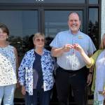 Eileen Schmitz, JACE Real Estate owner and Shipley Center board member, presents the keys of the former JCPenney building at 651 W. Washington St. to Shipley Center executive director Michael Smith following the centers Aug. 8 purchase of the building. At far left is Joyce Gladen of JACE Real Estate, and second from left is Shipley Center board secretary Margaret Cox. (Shipley Center)
