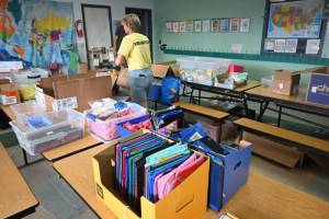 Kim Rosales and other volunteers help gather school supplies for students at last years Back to School Fair at the Sequim Boys & Girls Club. (Michael Dashiell/Olympic Peninsula News Group)
