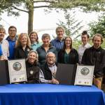 Martha Williams, director of the U.S. Fish & Wildlife Service, and Ron Allen, CEO and chairman of the Jamestown SKlallam Tribe (both seated), celebrate the signing of a co-stewardship agreement for the Dungeness and Protection Island National Wildlife Refuges on Aug. 16. (Jamestown SKlallam Tribe)