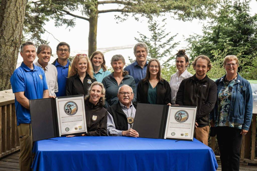 Martha Williams, director of the U.S. Fish & Wildlife Service, and Ron Allen, CEO and chairman of the Jamestown SKlallam Tribe (both seated), celebrate the signing of a co-stewardship agreement for the Dungeness and Protection Island National Wildlife Refuges on Aug. 16. (Jamestown SKlallam Tribe)