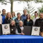 Martha Williams, director of the U.S. Fish & Wildlife Service, and Ron Allen, CEO and chairman of the Jamestown SKlallam Tribe (both seated), celebrate the signing of a co-stewardship agreement for the Dungeness and Protection Island National Wildlife Refuges on Aug. 16. (Jamestown SKlallam Tribe)
