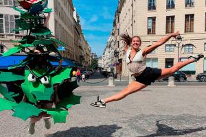 Ruby Coulson of Sequim, playing as the Stanford Tree, and gymnast Levi Jung-Ruivivar, who competed for the Philippines womens gymnastics team and is an incoming Stanford freshman, jump together in Paris during an interview promoting the universitys many Olympians. (Stanford Athletics)