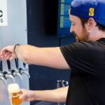 Social Fabric Brewing owner and brewer Levi Liberty pours himself a pilsner at a new brewery in Port Townsend. (Elijah Sussman/Peninsula Daily News)