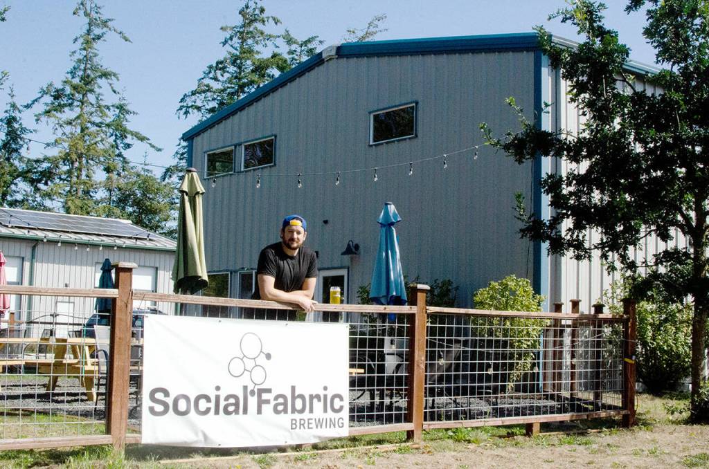 Brewery owner Levi Liberty in the beer garden at Social Fabric Brewing in Port Townsend on Tuesday. (Elijah Sussman/Peninsula Daily News)