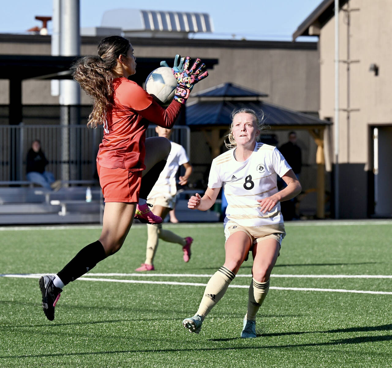 Peninsula Colleges Anna Petty battles Multnomah University goalkeeper Jennifer Alvilar for control of the ball during Tuesdays scrimmage at Walla Sigmar field in Port Angeles. (Jay Cline)