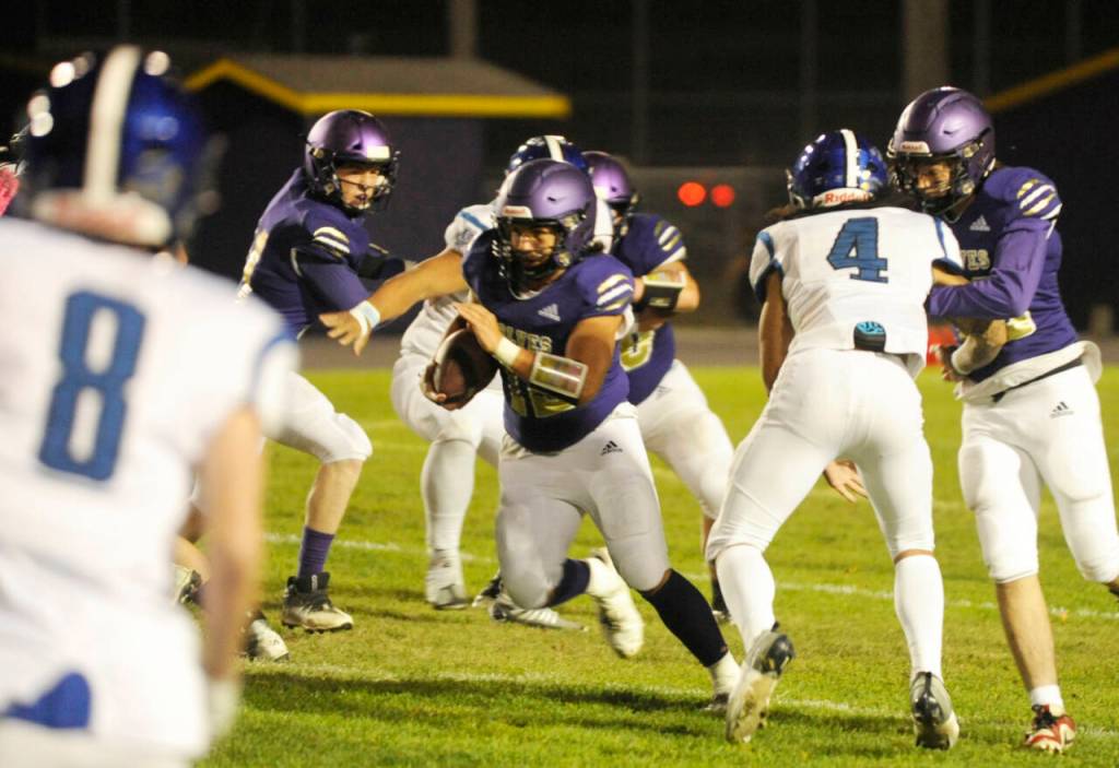 Sequim Gazette photo by Michael Dashiell / Sequim's Liam Wiker, center, finds a gaping hole in the North Mason defense in the second half of Sequim's 36-0 win on Oct. 13. Wiker led the team with 106 yards on 14 carries.