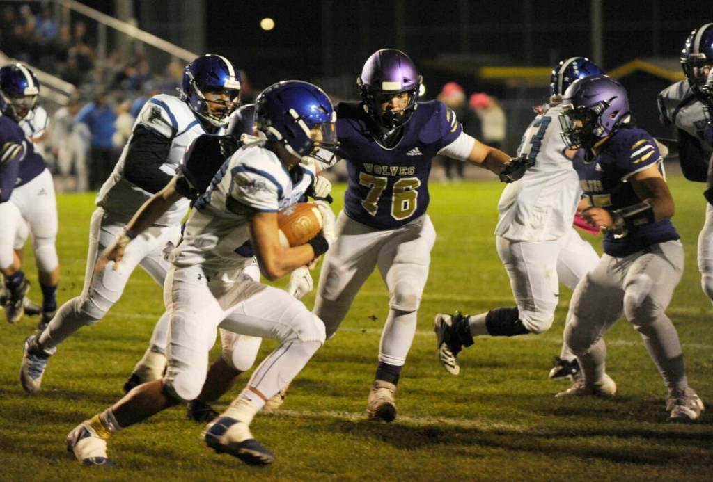 Sequim Gazette photo by Michael Dashiell / Sequims Nemo Guzman (76) and teammates stop North Mason for a loss in the Wolves 36-0 Olympic League victory on Oct. 13. The Wolves held the Bulldogs to just 35 yards rushing.
