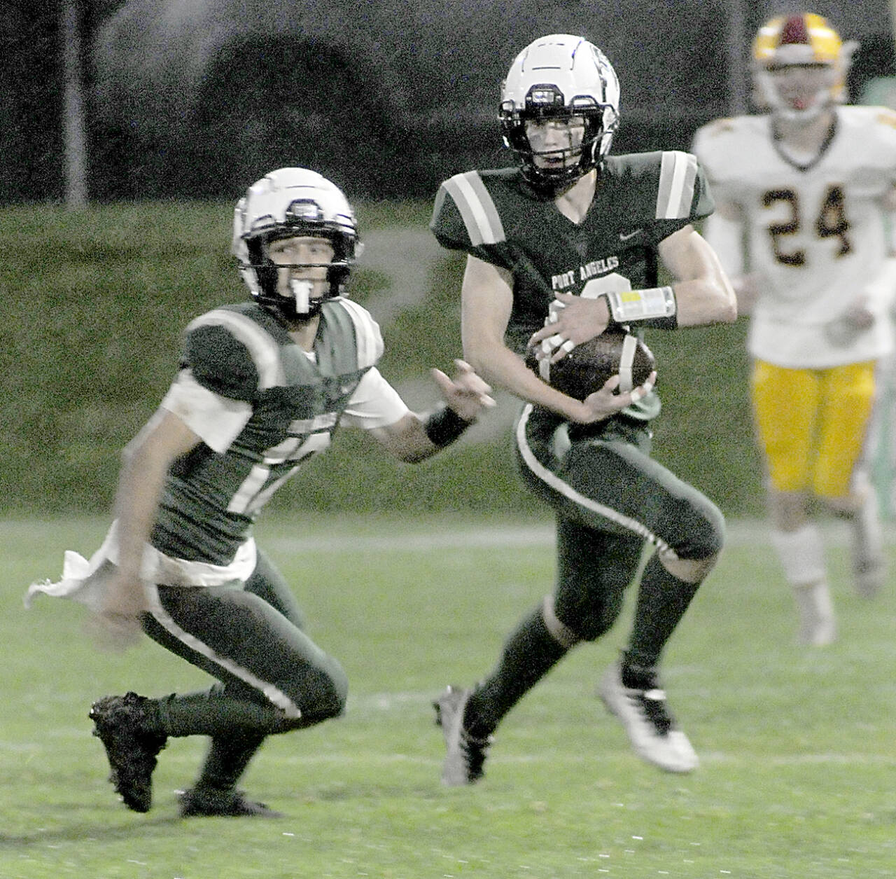KEITH THORPE/PENINSULA DAILY NEWS Port Angeles Blake Sohlberg, right, is followed by teammate Kason Albaugh, leaving Kingstons Noah Walter far behind on Friday at Port Angeles Civic Field.