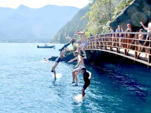 Looking to stay cool, several people jump off the Rainbow Bridge over the Devils Punch Bowl on the Spruce Railroad Trail on Lake Crescent in Olympic National Park over Labor Day weekend. A heat advisory has been issued by the National Weather Service with temperatures expected to reach the 80s and possibly the low 90s through today. (Dave Logan/for Peninsula Daily News)