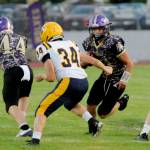 Michael Dashiell/Olympic Peninsula News Group Sequims quarterback Zeke Schmadeke runs with the ball against Forks. In on the play is the Spartans Landon Thomas (34).