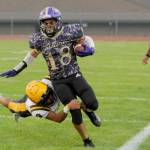 Sequims Malachi Hampton tries to get away from a tackle by Forks Bubba Hernandez in Fridays marquee matchup between the Wolves and Spartans in Sequim. Sequim came away with a 35-26 win. (Michael Dashiell/Olympic Peninsula News Group)