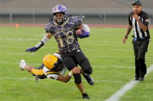 Sequims Malachi Hampton tries to get away from a tackle by Forks Bubba Hernandez in Fridays marquee matchup between the Wolves and Spartans in Sequim. Sequim came away with a 35-26 win. (Michael Dashiell/Olympic Peninsula News Group)