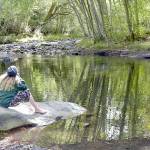 Laura Lee Wadsworth of Sequim looks out on Morse Creek near the Olympic Discovery Trail east of Port Angeles on Tuesday. Wadsworth said the creek is a peaceful place to enjoy a late-summer day. (Keith Thorpe/Peninsula Daily News)