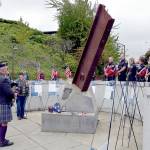 Rick McKenzie, a retired Coast Guard veteran, plays bagpipes at the 9/11 memorial at the Francis Street Park in Port Angeles on Wednesday. (Keith Thorpe/Peninsula Daily News)