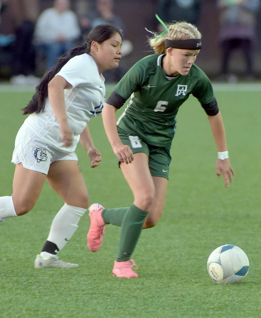 KEITH THORPE/PENINSULA DAILY NEWS Port Angeles Pyper Alton dribbles past North Masons Magdalena Miguel Sebastian during Wednesdays match at Peninsula College in Port Angeles.