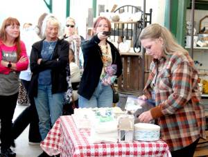 Kelly Grable of Mobile, Ala., prepares Bellas birthday cake outside Forks Outfitters in Forks on Thursday as Forever Twilight in Forks fans look on. Isabella Bella Marie Cullen (née Swan) was born to Charlie Swan and Renée Dwyer on Sept. 13, 1987. The Twilight series main protagonist celebrated a day early as the store played along and paged her over the public address system. Grable is a member of the Forever Twilight Forks planning committee and travels to Forks each year to help with the festival. More than 400 VIT (Very Important Twilighter) tickets were sold. Planned VIT and other free activities continue throughout town and to La Push through Sunday. (Christi Baron/Olympic Peninsula News Group)