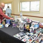 Paulo Leite of Port Angeles sets up a display of automotive and Star Wars toys at Saturdays Olympic Peninsula Toy and Collectibles Show at Guy Cole Convention Center in Sequim. The exhibition featured a wide variety of toys and collectible items for display, sale or trade. (Keith Thorpe/Peninsula Daily News)