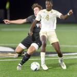 KEITH THORPE/PENINSULA DAILY NEWS Peninsulas Jeremie Kuelo, front, defends the ball from Everetts Caleb Hirata during Wednesdays match at Wally Sigmar Field.