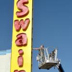 Seth Stewart of Silverdale-based Hanson Signs inspects the side panels on a new business sign at Swains General Store in Port Angeles on Thursday. Swains general manager Don Droz said the original iconic sign dated back to the 1960s and was in need being replaced. Droz said the neon-lit lettering from the old sign was preserved and incorporated into the new marquee. (Keith Thorpe/Peninsula Daily News)