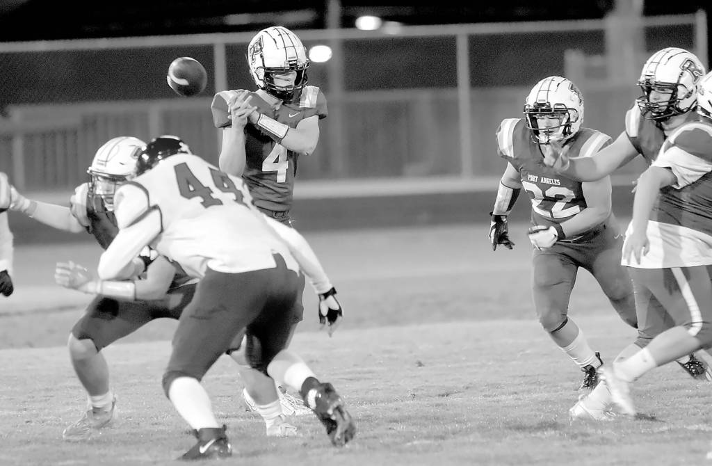 KEITH THORPE/PENINSULA DAILY NEWS
Port Angeles quarterback Blake Sohlberg has the snap get away from him during Friday's game against North Mason at Port Angeles Civic Field.