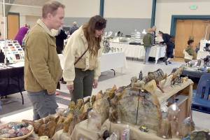 Jason Eason, left, and Amanda Krott, both of Bremerton, examine a collection of rocks and minerals on display by Rockin the Castle of Lebanon, Ore., during Saturdays Gem, Rock and Jewelry Show at Vern Burton Community Center in Port Angeles. The show, hosted by the Clallam County Gem and Mineral Association, featured a wide variety of exhibits as well as an area devoted to childrens activities. (Keith Thorpe/Peninsula Daily News)