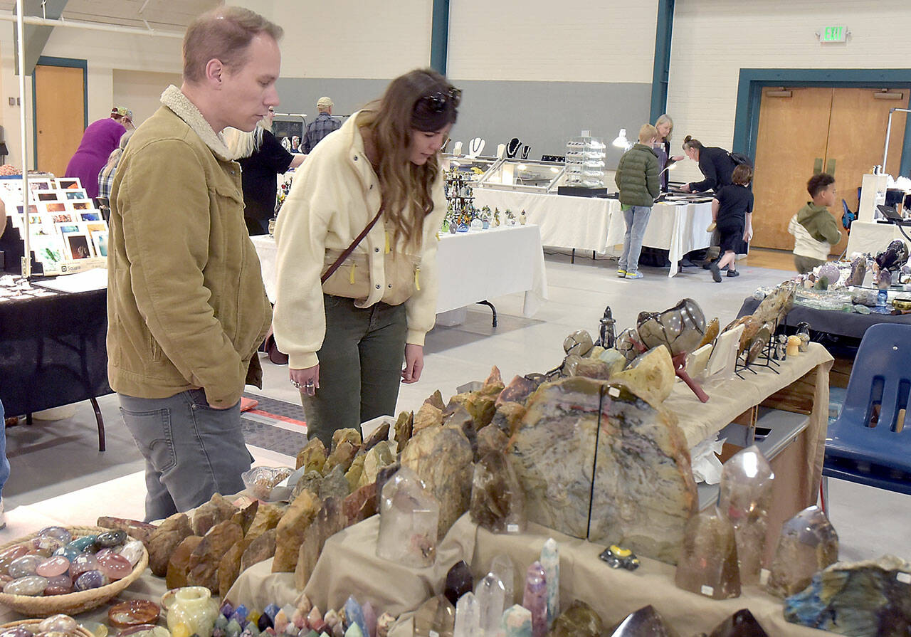 Jason Eason, left, and Amanda Krott, both of Bremerton, examine a collection of rocks and minerals on display by Rockin the Castle of Lebanon, Ore., during Saturdays Gem, Rock and Jewelry Show at Vern Burton Community Center in Port Angeles. The show, hosted by the Clallam County Gem and Mineral Association, featured a wide variety of exhibits as well as an area devoted to childrens activities. (Keith Thorpe/Peninsula Daily News)