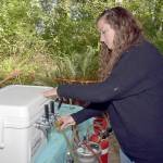 Moya Cavanagh, a teacher with Olympic Nature Experience, pours a taster glass with beer during Saturdays Beer in the Woods at Websters Woods at the Port Angeles Fine Arts Center. The event featured food, music, youth activities and samples of various breweries around Northwest Washington. (Keith Thorpe/Peninsula Daily News)