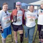 Members of the So Every BODY Can Move teams competing at the Big Hurt get await their mountain bike teammates Saturday at Pebble Beach in Port Angeles. From left are Katya Madden (kayak), Nicole Ver Kuilen (cycling, running), Sierra Landholm (kayak) and Katy Gaastra (cycling). The group is working to require insurance companies to help pay for orthotics and prosthetics so people can not only be mobile but to be able to run and cycle. (Keith Thorpe/Peninsula Daily News)