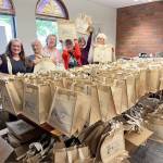 From left, Shauna Kohl, Melissa Moller, Rebecca Knieval, Nancy Elder, Lorilee Houston and Sue Arthur with some of the 400 goodie bags for sale Thursday at the Port Townsend Main Street Programs annual Girls Night Out fundraiser.