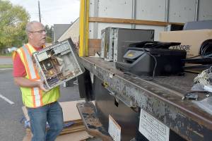 Olympic Kiwanis Club member Tom Clark of Joyce loads a discarded computer onto a truck for recycling during Saturdays e-Waste Recycling Day at in the parking lot at Port Angeles Civic Field. The club took in stacks of used computers, television sets, printers and other home electronics with donations going to the clubs childrens programs. (Keith Thorpe/Peninsula Daily News)