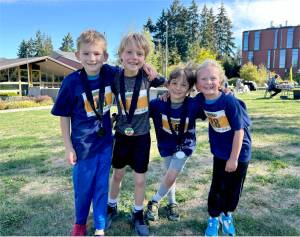 The top racers in the first- through second-grade division at the Little Hurt celebrate their medals Sunday. From left are Kelton Fogerty, Henry Herschmiller, Isaac Simoneau and Magnus Jensen. Herschmiller won his age group. (Photo by Courtney Nestler)