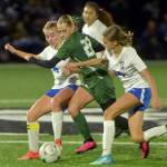 KEITH THORPE/PENINSULA DAILY NEWS Port Angeles Teanna Clark, center, moves with the pack of Bremertons Melanie Uhrich, left, and Mia Alexander in Tuesdays match in Port Angeles.